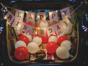 Red & White Car Boot Birthday Surprise Decoration with Balloons, Cake & Fairy Lights | JMD Events Gwalior